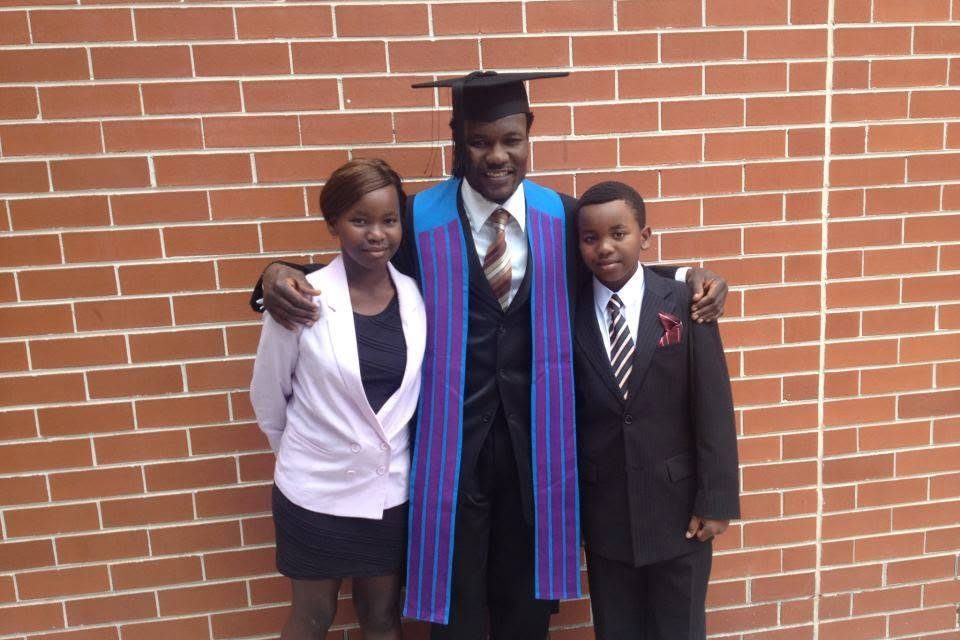 Lovemore Ndou with his two children at his university graduation