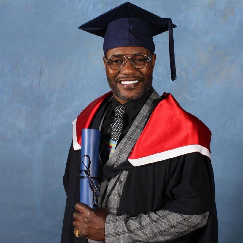 Lovemore Ndou in academic gown and cap at his graduation