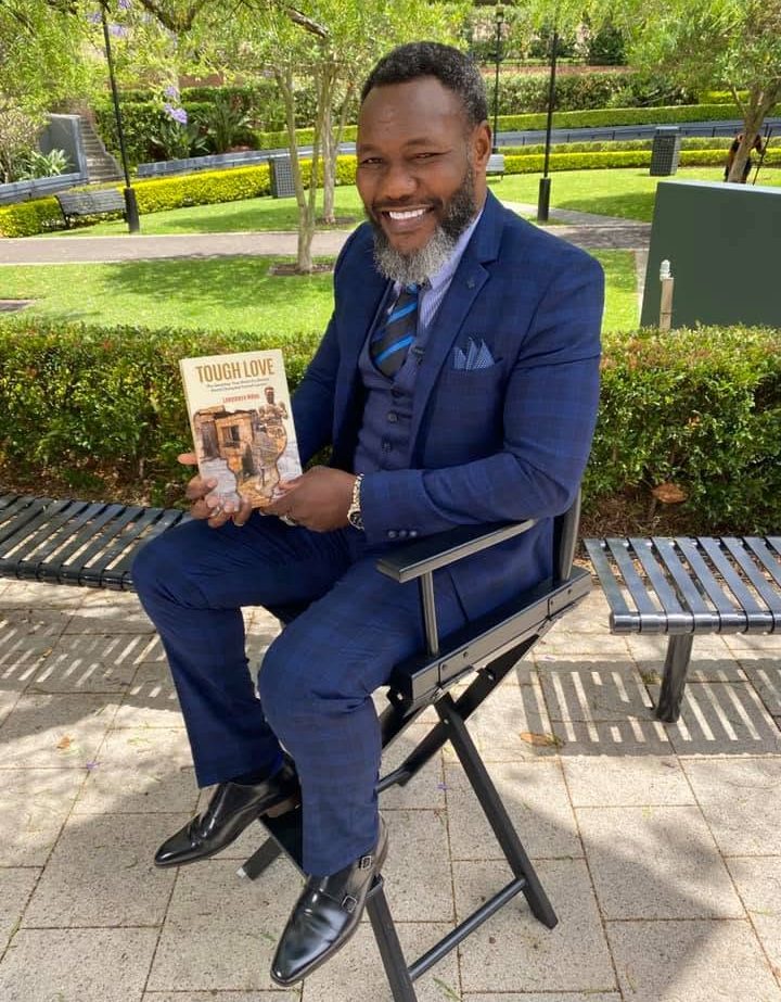 Lovemore Ndou holding his memoir, Tough Love